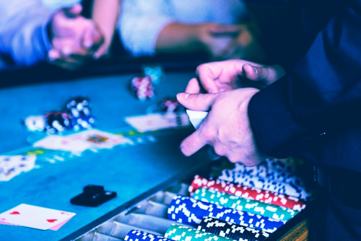 a blackjack dealer deals cards to two players