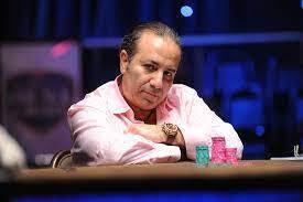 sam farha professional poker player playing poker with stacked chips in front of him