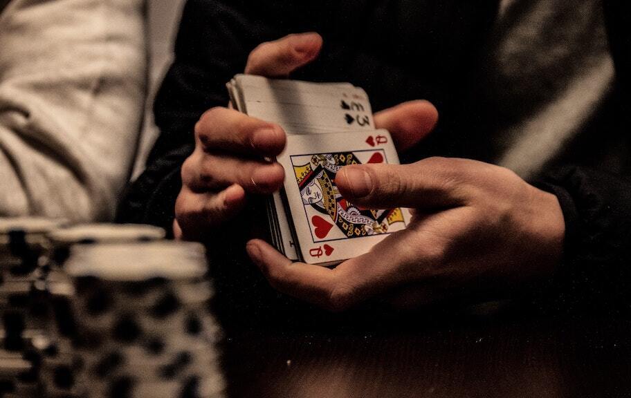 poker player shuffling deck of cards