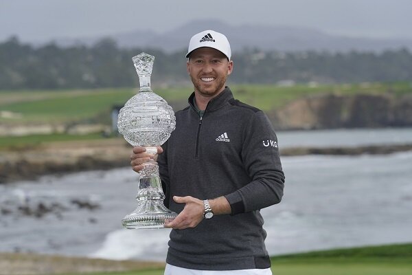Daniel Berger poses with the trophy at Pebble Beach