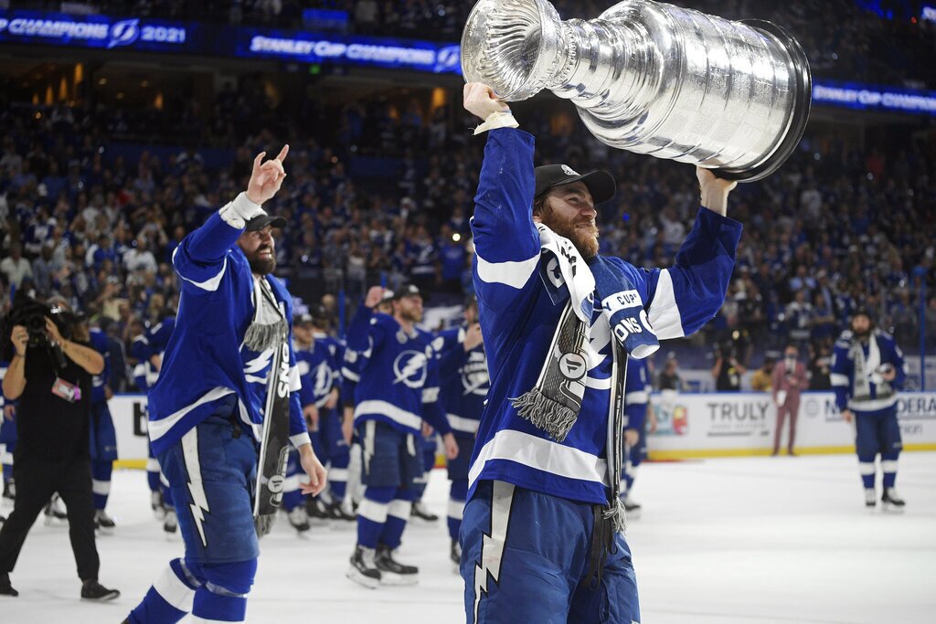 hockey player holds the Stanley cup over his head